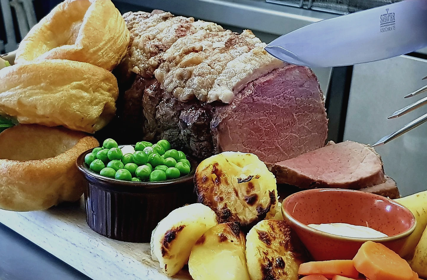 Sunday roast with beef, Yorkshire puddings and vegetables