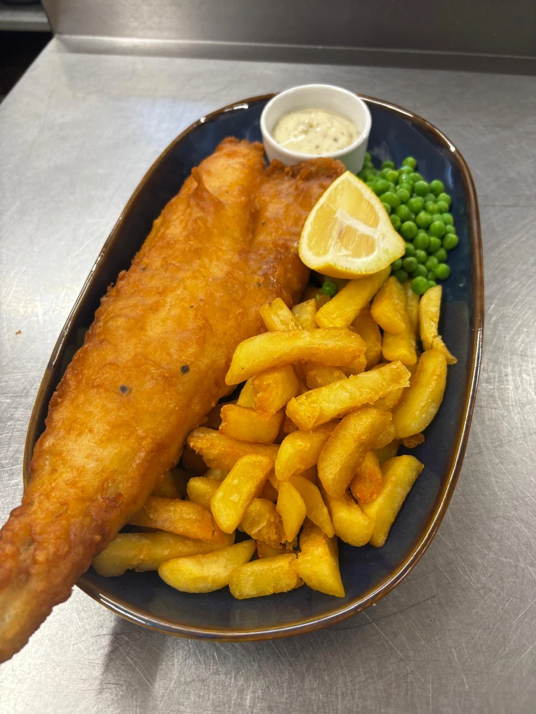 Fish and chips with peas and lemon